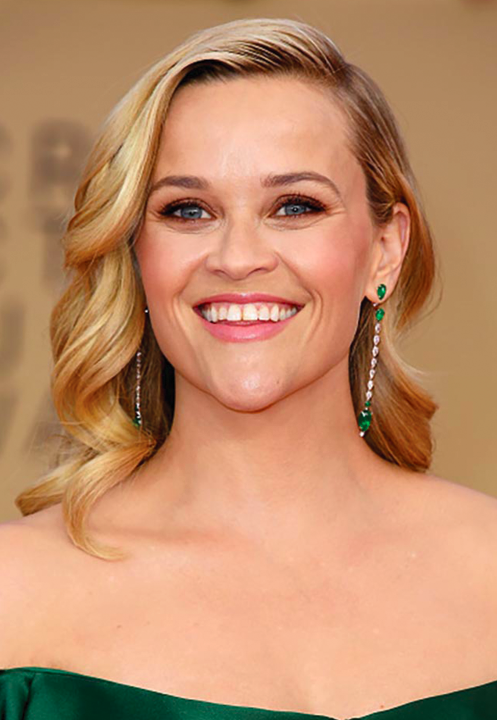 Reese Witherspoon in a Zac Posen dress with complementing emerald and diamond earrings.